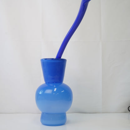 blue hand-blown glass vase with sculptural handblown glass flowers and blue prongs, creating a bold, artistic statement piece for interiors