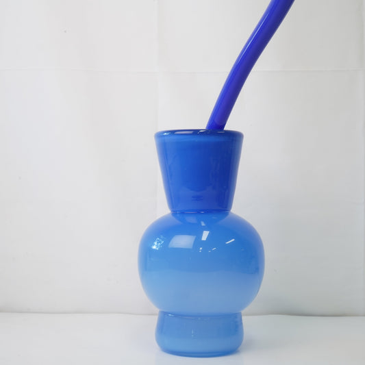 blue hand-blown glass vase with sculptural handblown glass flowers and blue prongs, creating a bold, artistic statement piece for interiors