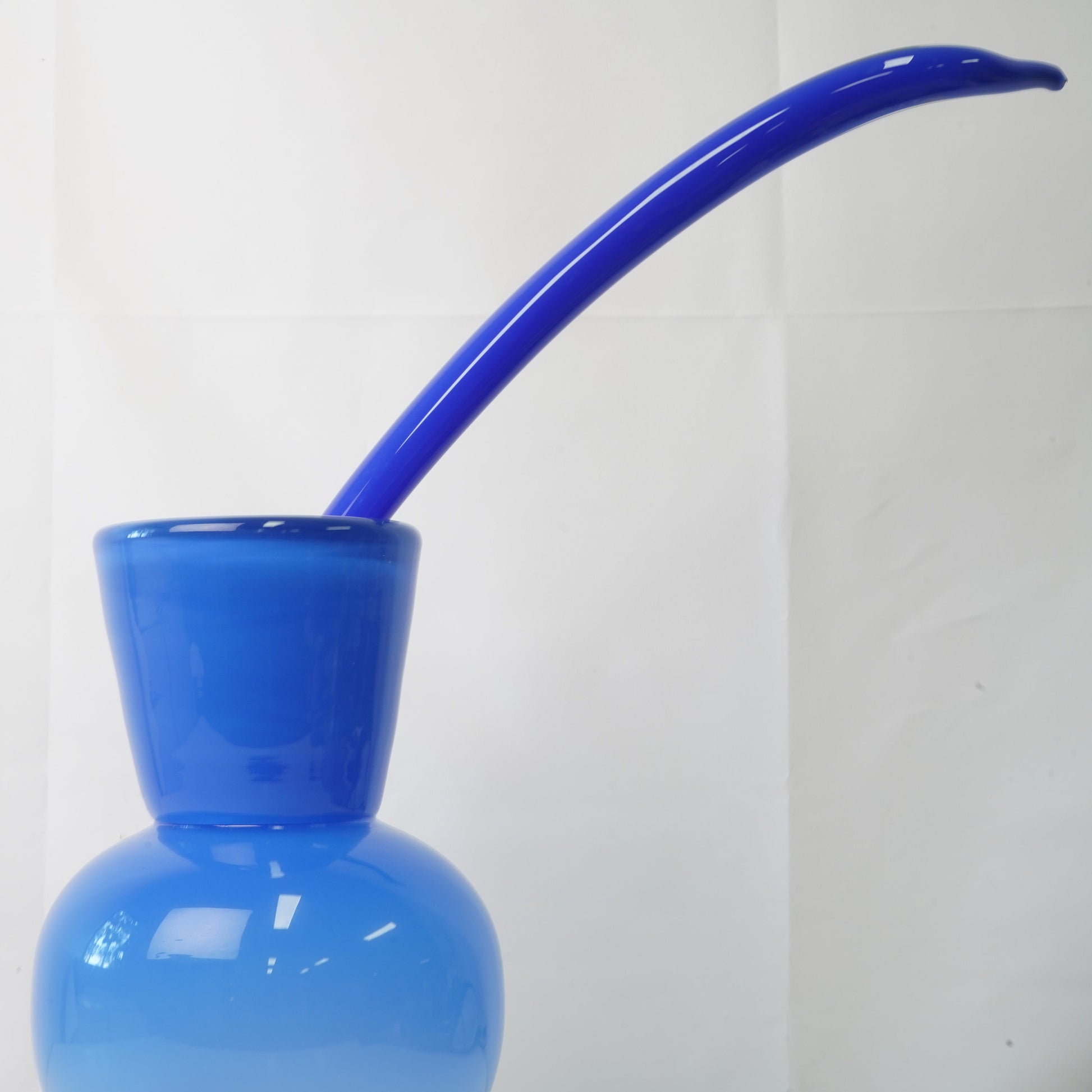 blue hand-blown glass vase with sculptural handblown glass flowers and blue prongs, creating a bold, artistic statement piece for interiors
