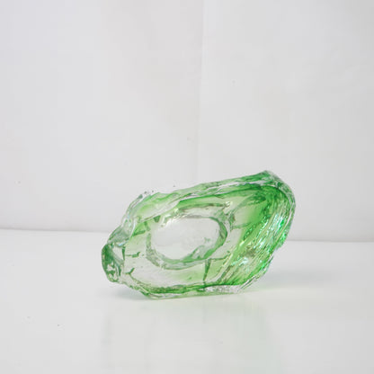 A textured green glass sculptural piece
Handcrafted green glass object with textured finish