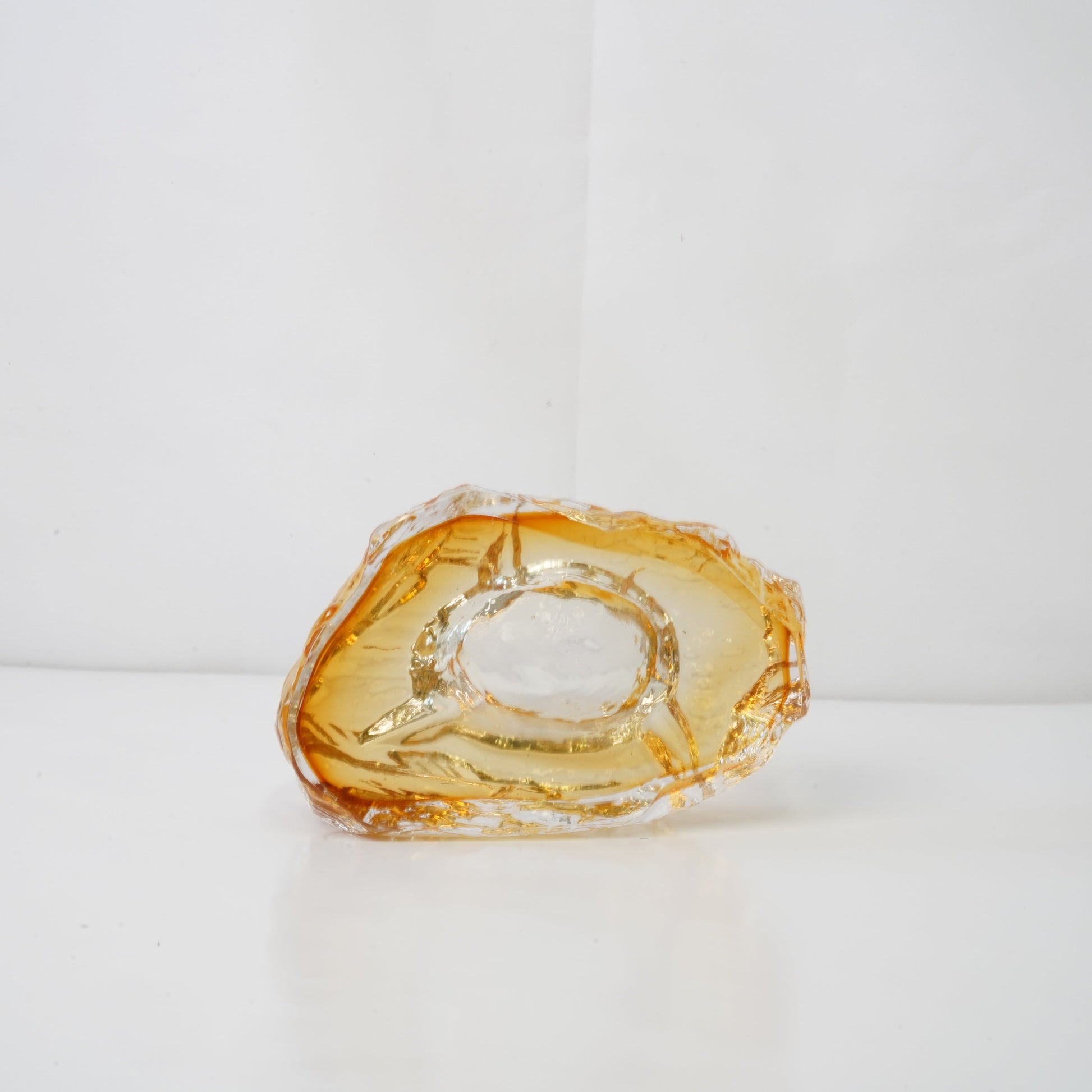A textured orange glass sculptural piece
Handcrafted green glass object with textured finish