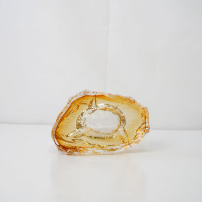 A textured orange glass sculptural piece
Handcrafted green glass object with textured finish